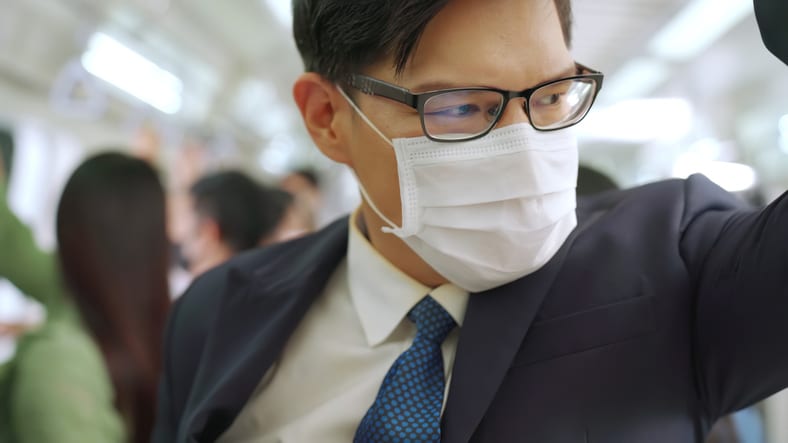 Japanese man on train wearing mask